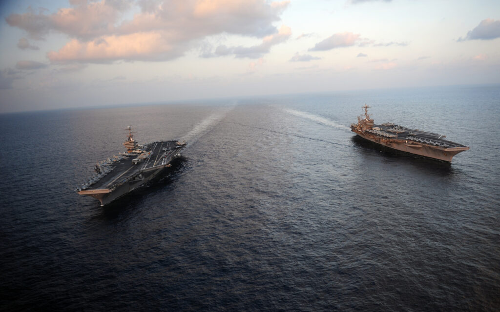 Two U.S. Navy aircraft carriers, USS Abraham Lincoln and USS John C. Stennis, operating in the Arabian Sea during 5th Fleet missions.