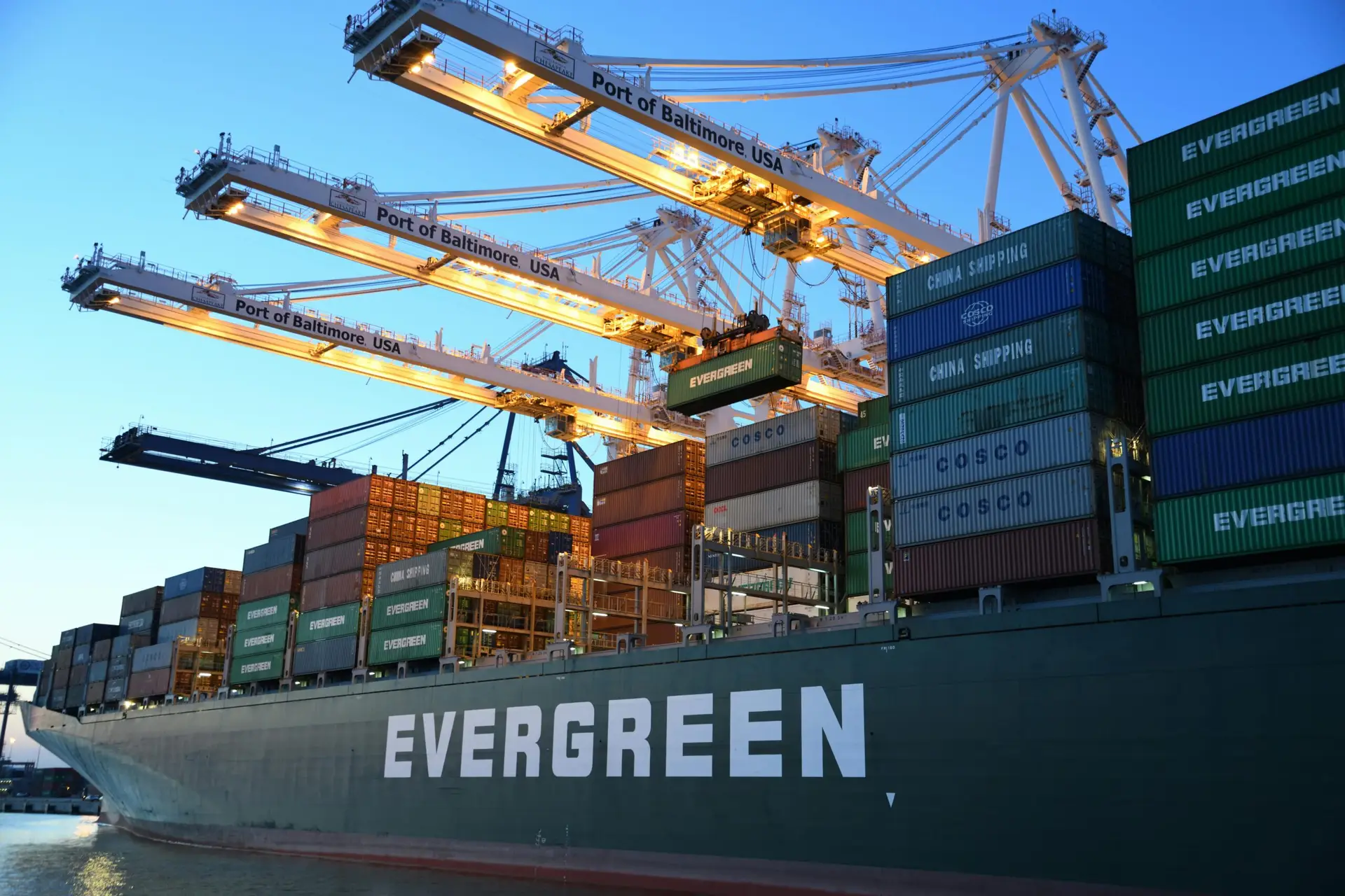 A large Evergreen cargo ship at the Port of Baltimore, symbolizing global trade tensions and the impact of Trump tariffs on international power inequality