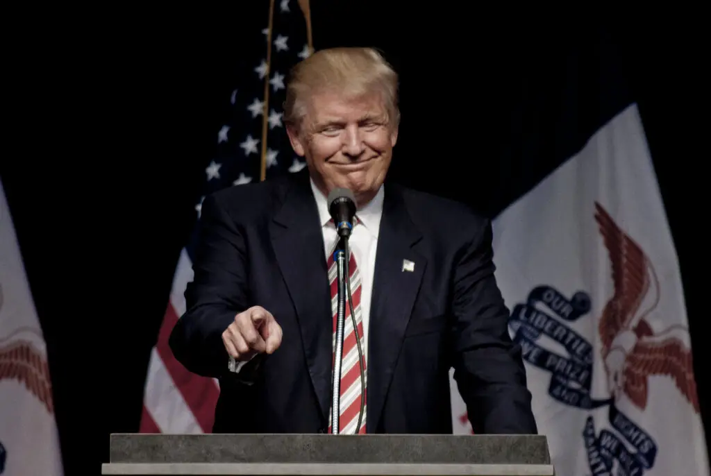 Donald Trump speaking at a podium during a campaign rally, symbolizing the public messaging referenced in the article.